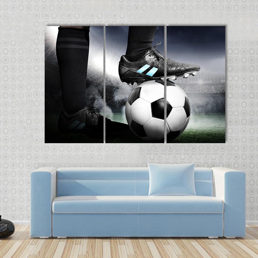Soccer Player with Soccer Ball Canvas Wall Art in black, white and gray, 3 panel horizontal set hung on a wall