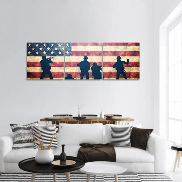 Soldier Silhouettes on Weathered American Flag Panoramic Canvas Wall Art in beige, red and blue, hung on a wall