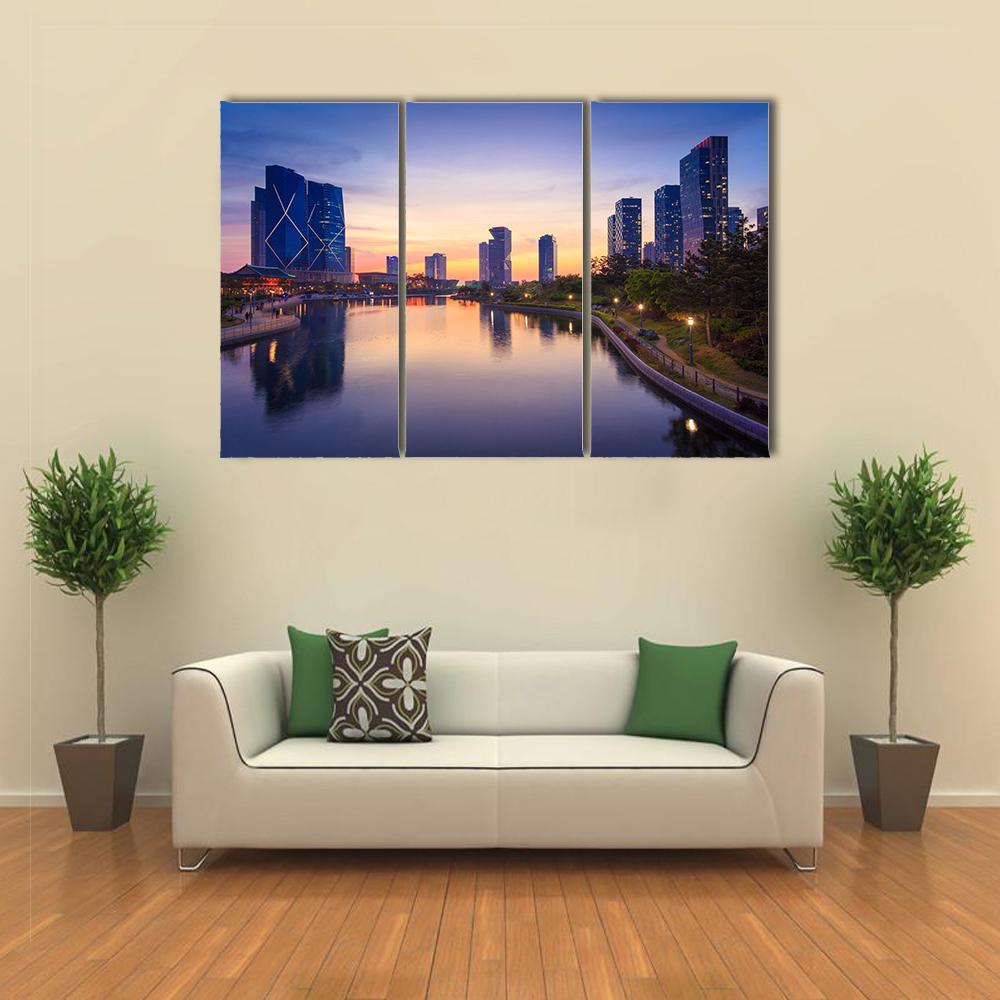 Songdo Central Park at Sunset Canvas Wall Art in orange, blue and purple, 3 panel horizontal set hung on a wall