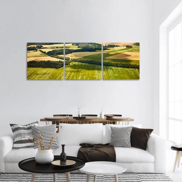 South Bohemian Fields Landscape Panoramic Canvas Wall Art in beige, yellow and green, hung on a wall