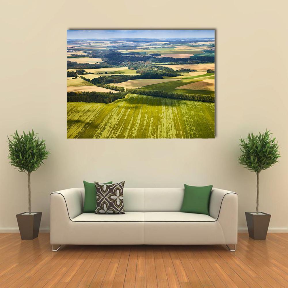 South Bohemian Fields and Forests Canvas Wall Art in yellow, green and blue, single panel hung on a wall