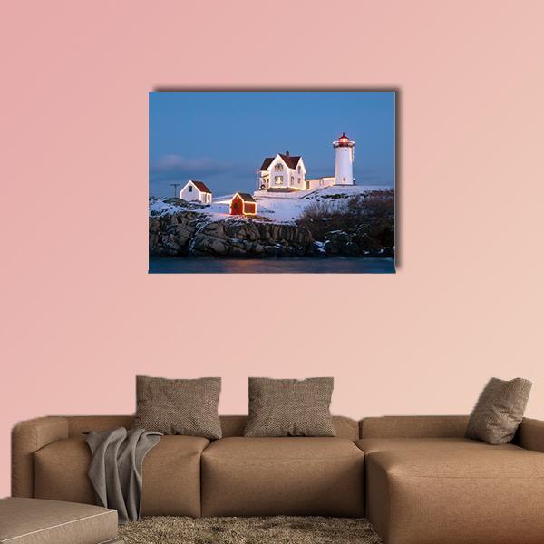 Nubble Lighthouse at Winter Dusk Canvas Wall Art in white and blue, single panel hung on a wall