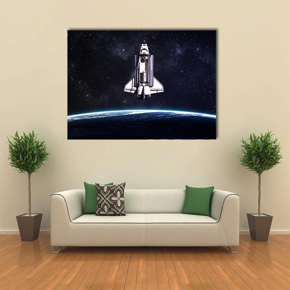 Space Shuttle Over Earth Canvas Wall Art in black, white and blue, single panel hung on a wall