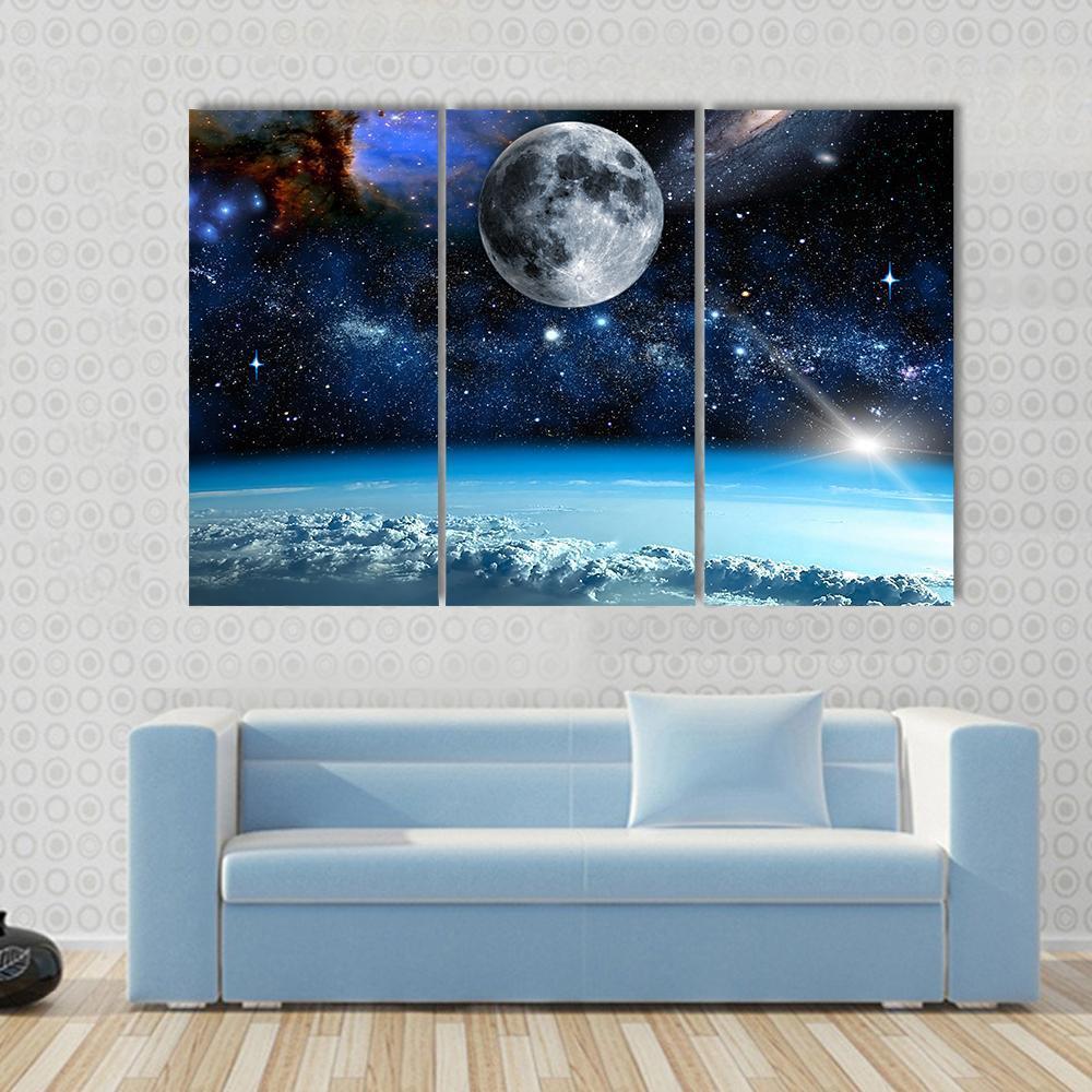 Space View from Earth Canvas Wall Art in black, white and blue, 3 panel horizontal set hung on a wall
