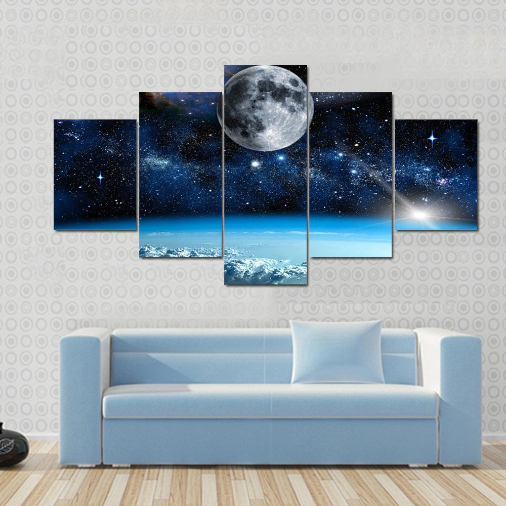 Space View from Earth Canvas Wall Art in black, white and blue, 5 panel Star layout hung on a wall