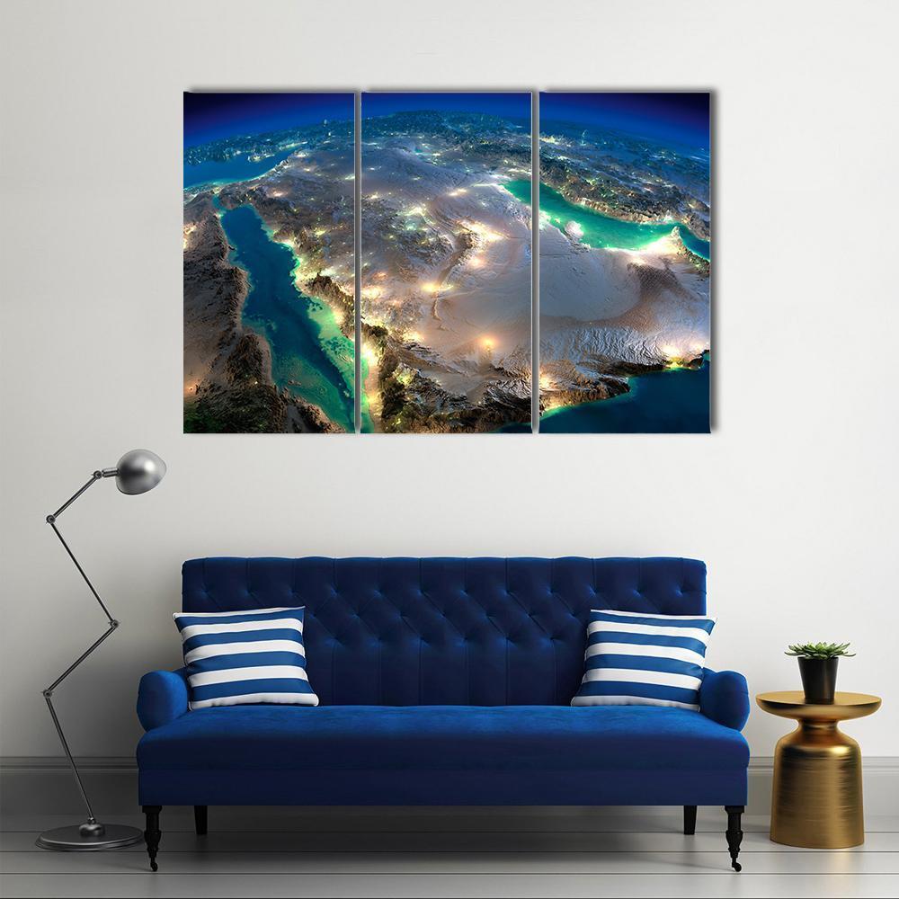 Saudi Arabia from Space at Night Canvas Wall Art in black, gold and blue, 3 panel horizontal set hung on a wall