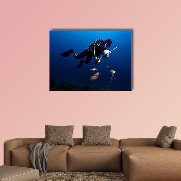 Spear Fisherman with Speargun Canvas Wall Art in black and blue, single panel hung on a wall