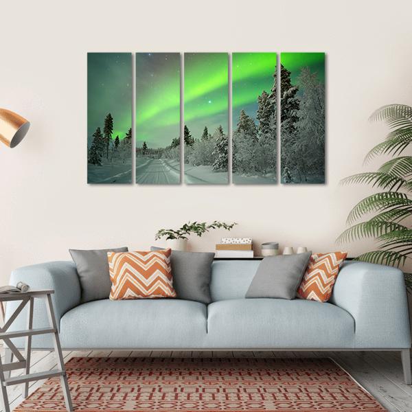 Aurora Borealis Over Snowy Road Canvas Wall Art in white, gray and green, single panel hung on a wall