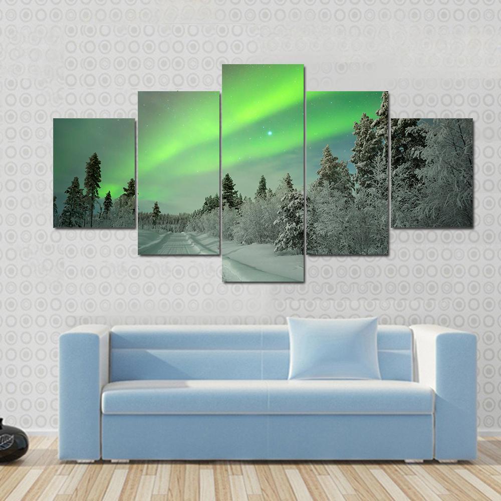 Aurora Borealis Winter Landscape Canvas Wall Art in white and green, 4 panel Pop layout hung on a wall