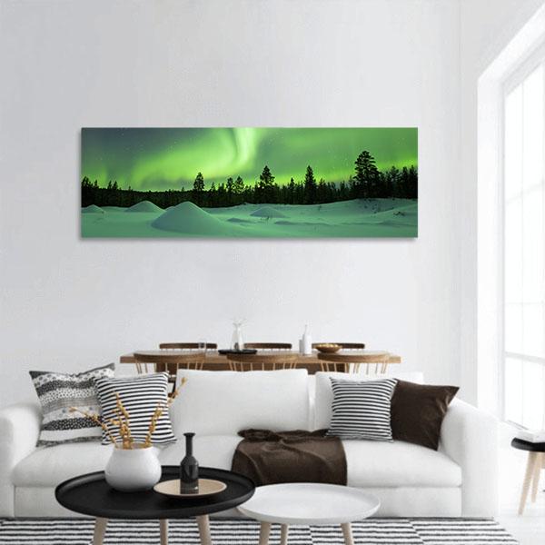 Aurora Borealis Over Snowy Pine Forest Panoramic Canvas Wall Art in black, white and green, single panel hung on a wall