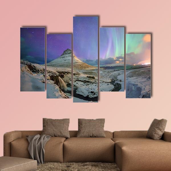Northern Lights Over Kirkjufell Canvas Wall Art in white, green and purple, 3 panel horizontal set hung on a wall