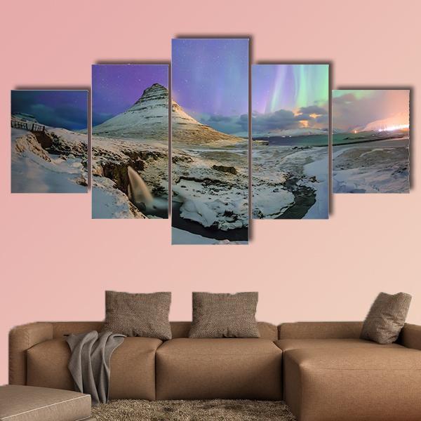 Northern Lights Over Kirkjufell Canvas Wall Art in white, green and purple, 3 panel horizontal set hung on a wall