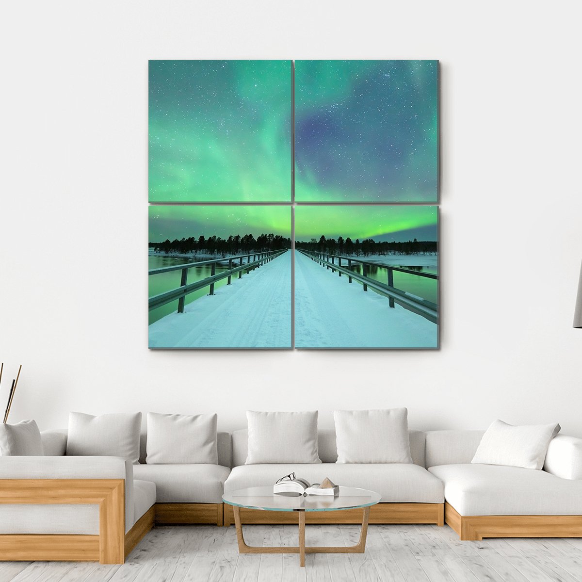 Northern Lights Over Snowy Bridge and River Canvas Wall Art in white, green and blue, hung on a wall