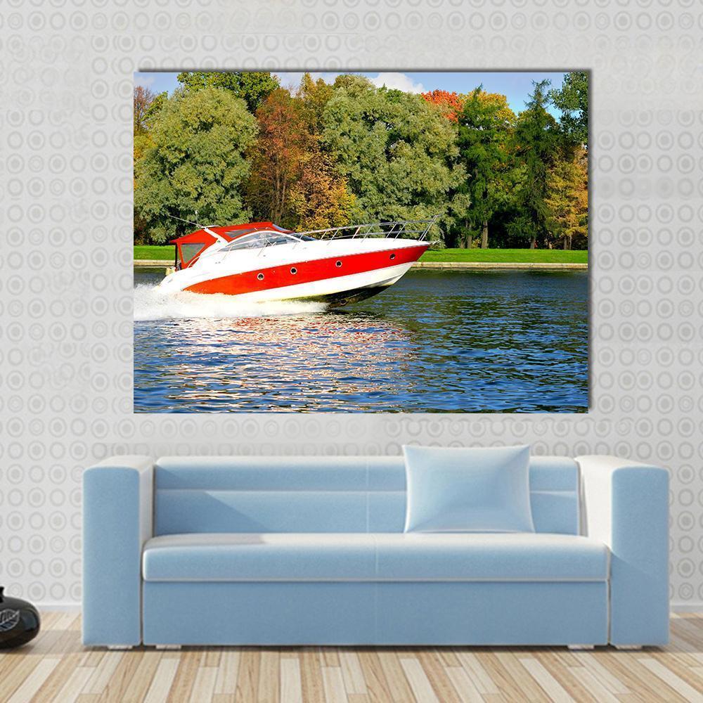 Red Motorboat Cutting Through Autumn Wake Canvas Wall Art in red, green and blue, single panel hung on a wall