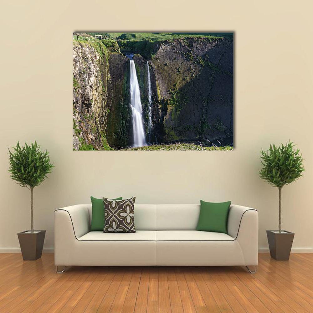Twin Streams Over Mossy Canyon Canvas Wall Art in black, gray and green, single panel hung on a wall