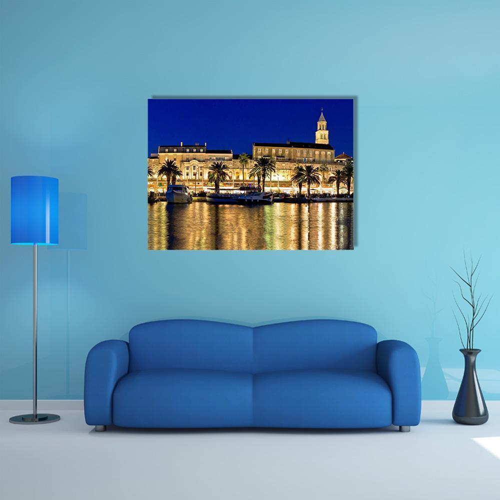 Evening Waterfront with Palm Trees and Boats Canvas Wall Art in gold, yellow and blue, single panel hung on a wall