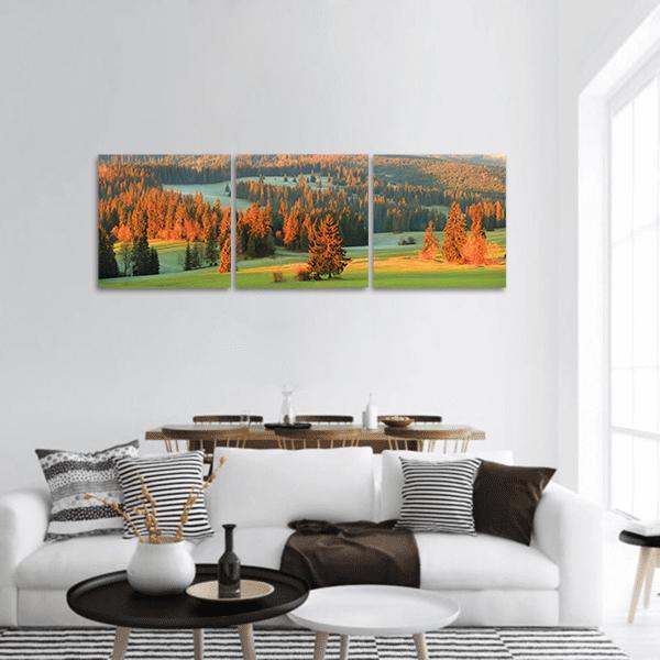 Spring Green Valley with Pine Trees Panoramic Canvas Wall Art in orange, yellow and green, single panel hung on a wall