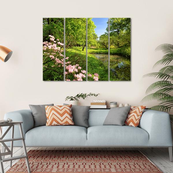 Spring Pond with Rhododendrons and Pink Azaleas Canvas Wall Art in green, blue and pink, hung on a wall