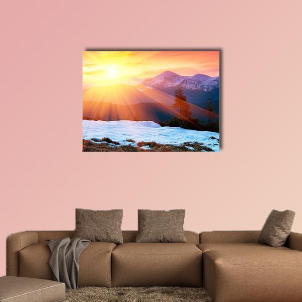Snowy Mountain Sunset with Cloudy Sky Canvas Wall Art in white, orange and yellow, single panel hung on a wall