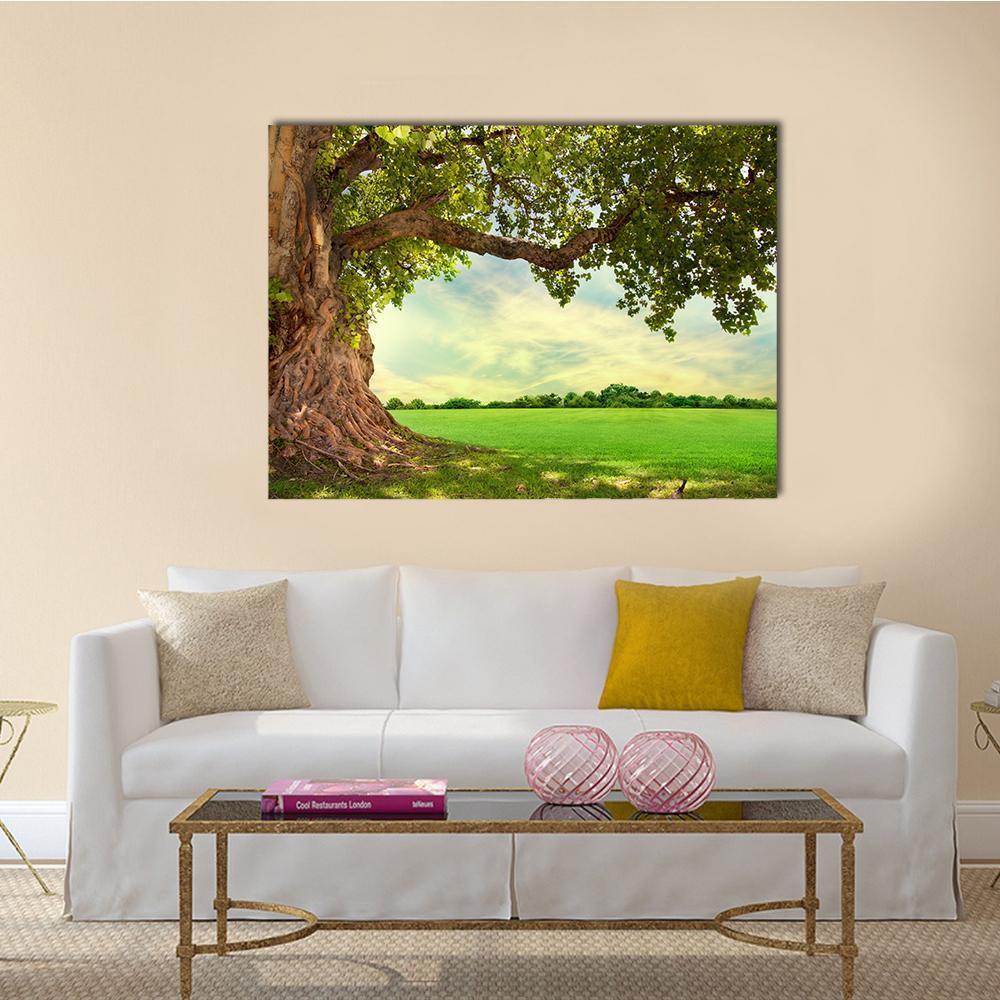 Spring Meadow with Big Tree Canvas Wall Art in brown, green and blue, single panel hung on a wall