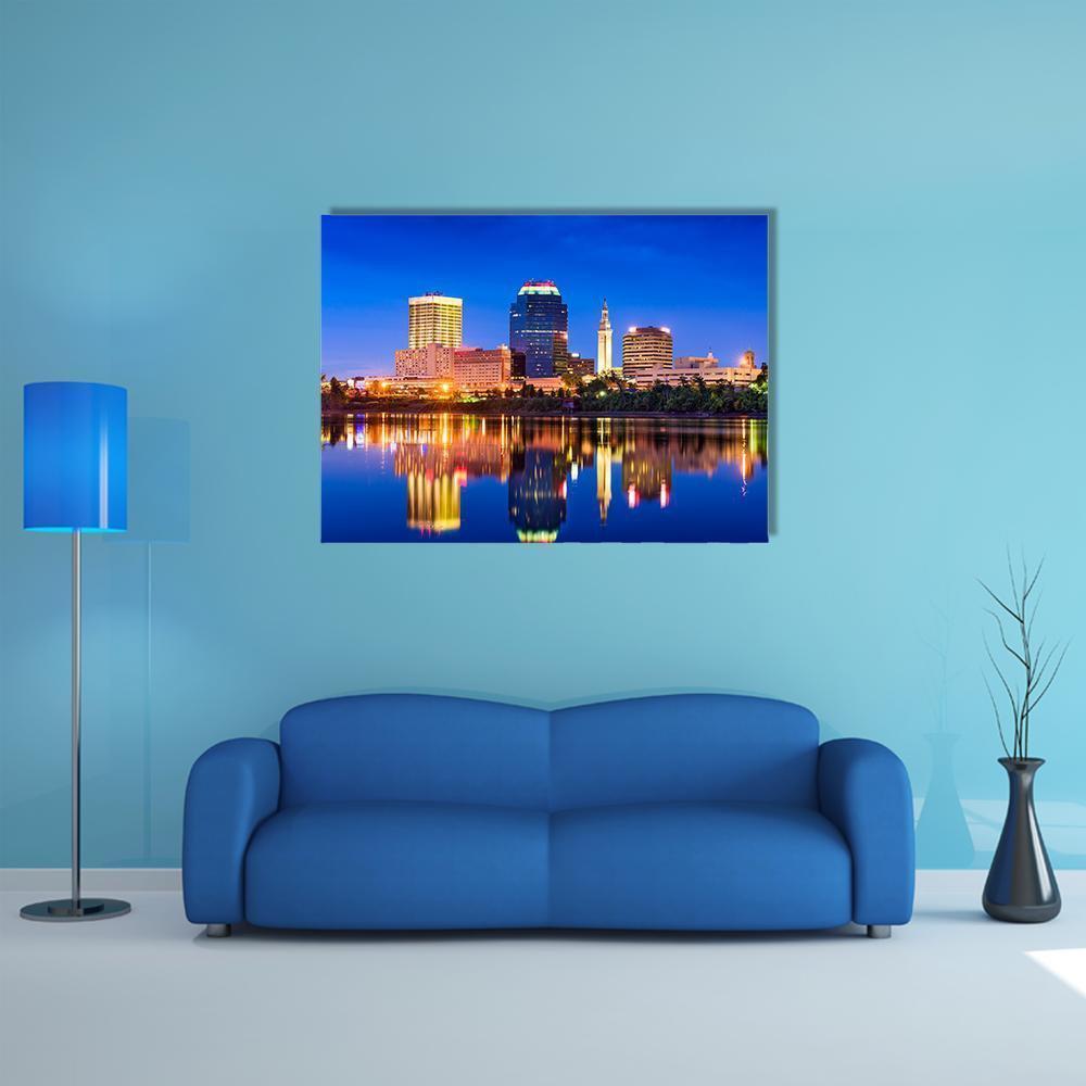 Springfield Night Skyline with Water Reflection Canvas Wall Art in yellow, blue and navy, single panel hung on a wall