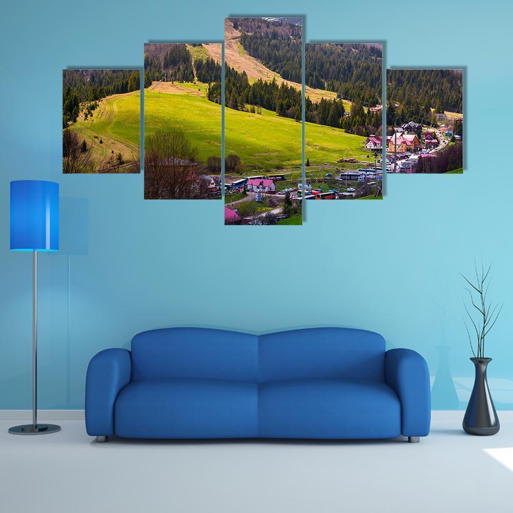 Carpathian Mountain Village in Spring Canvas Wall Art in brown, green and blue, 5 panel Star layout hung on a wall