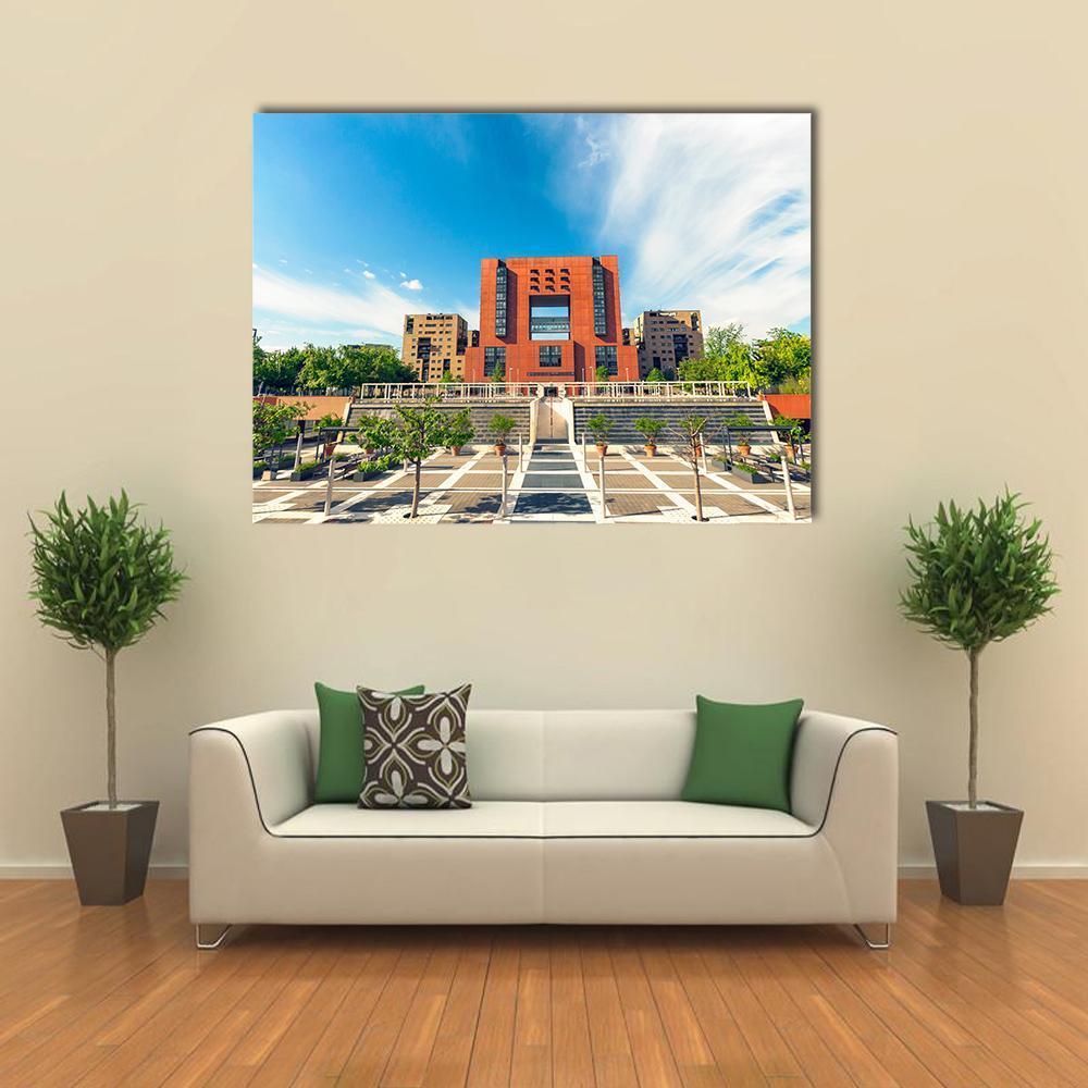 Square of Bicocca University Canvas Wall Art in gray, orange and blue, single panel hung on a wall