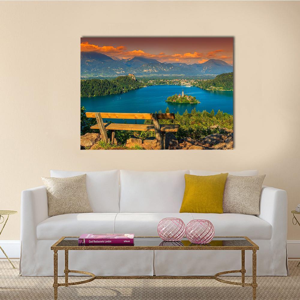 St Mary's Church on Lake Bled Canvas Wall Art in orange, green and blue, single panel hung on a wall
