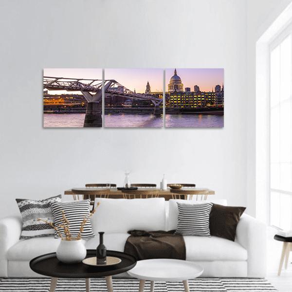 Millennium Bridge to St Paul's Cathedral at Dusk Panoramic Canvas Wall Art in orange, blue and purple, hung on a wall