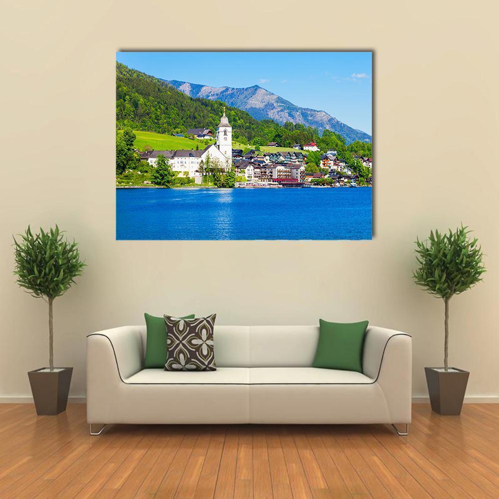 St Wolfgang Church by the Lake Canvas Wall Art in green and blue, single panel hung on a wall