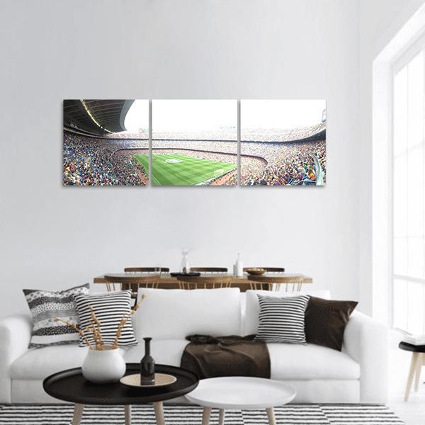 Stadium Crowd Over Soccer Pitch Panoramic Canvas Wall Art in white, gray and green, hung on a wall