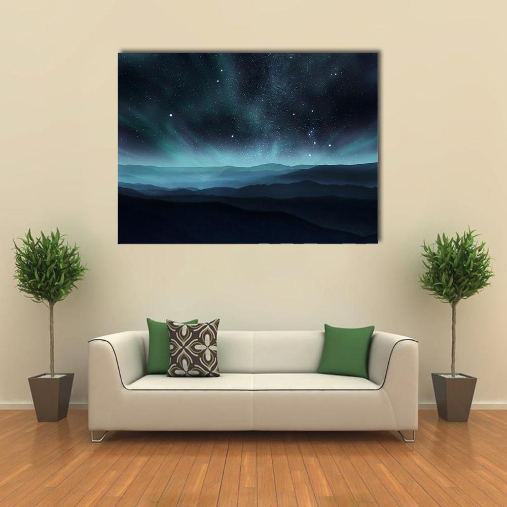Aurora Over Layered Mountain Ranges Canvas Wall Art in black, green and blue, single panel hung on a wall