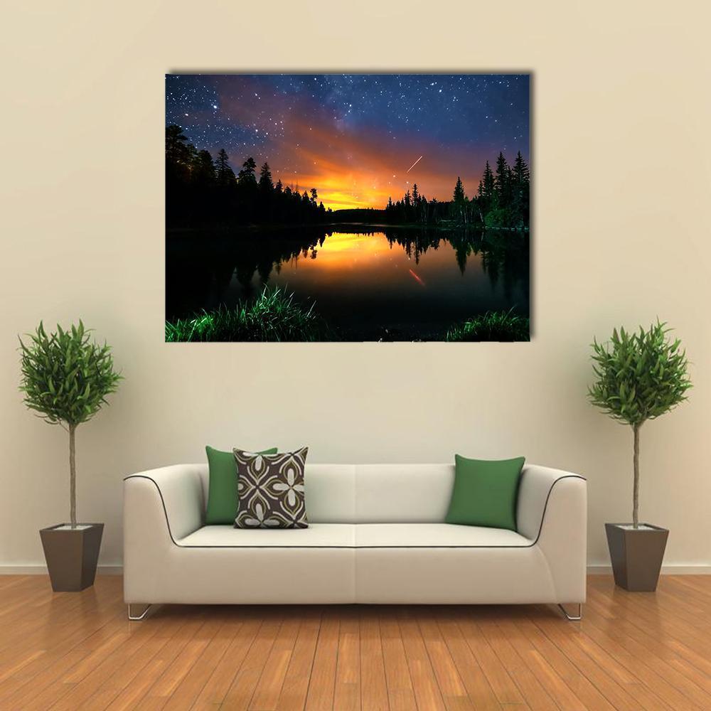 Milky Way Over Forest and Lake Canvas Wall Art in black, orange and blue, single panel hung on a wall