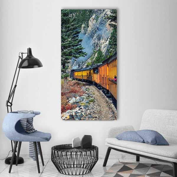 Vintage Steam Train Through Mountain Forest Vertical Canvas Wall Art in gray, orange and green, single vertical panel hung on a wall