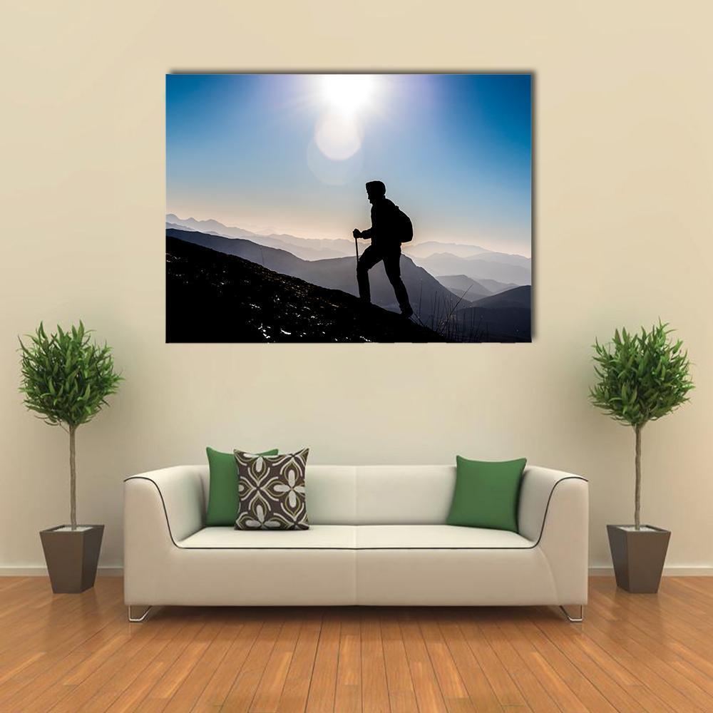 Hiker Silhouette on Mountain Trail Canvas Wall Art in black, white and blue, single panel hung on a wall