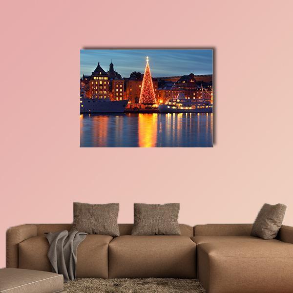 Stockholm Old City with Christmas Tree Canvas Wall Art in orange, yellow and blue, single panel hung on a wall