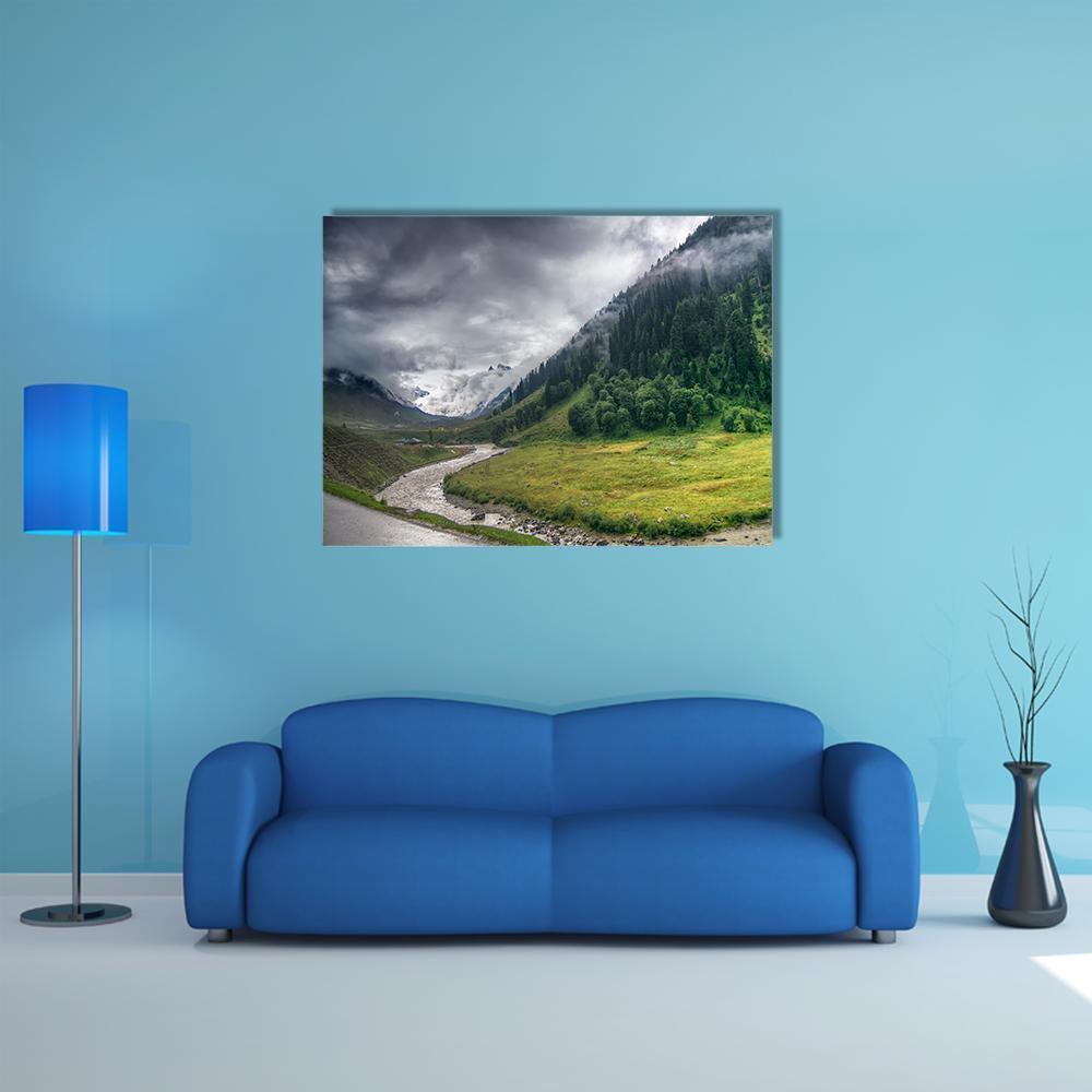 Storm Clouds Over Snow-capped Mountains Canvas Wall Art in white, gray and green, single panel hung on a wall