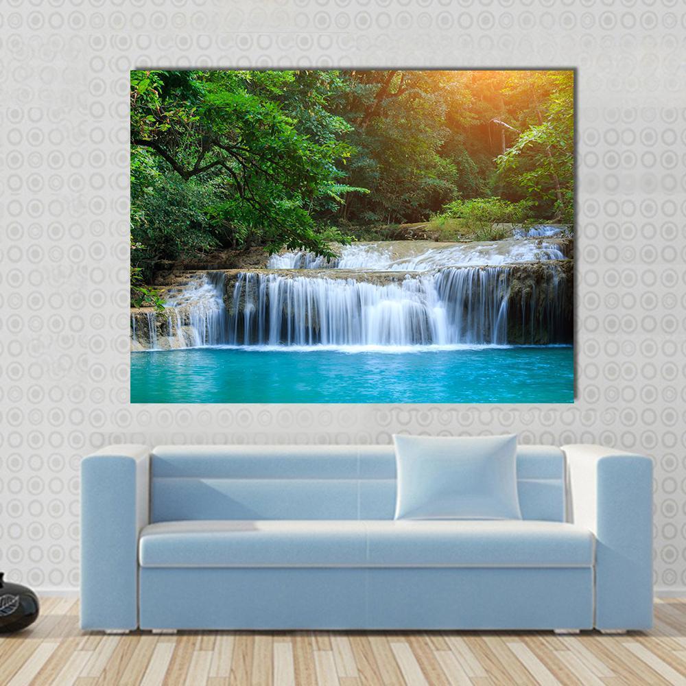 Stream in Green Forest Canvas Wall Art in brown, green and blue, single panel hung on a wall