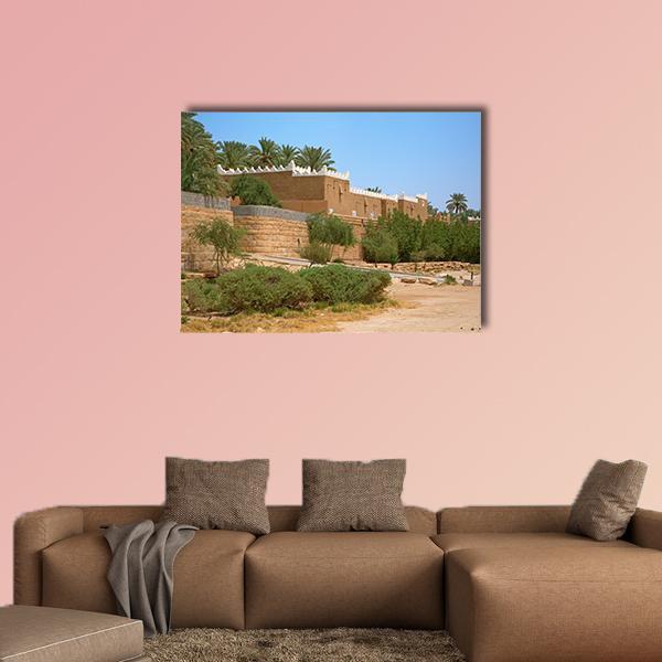 Old City Streets of Diriyah Canvas Wall Art in brown, green and blue, single panel hung on a wall