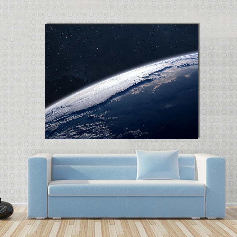 View of Earth from Space Canvas Wall Art in black, white and blue, single panel hung on a wall