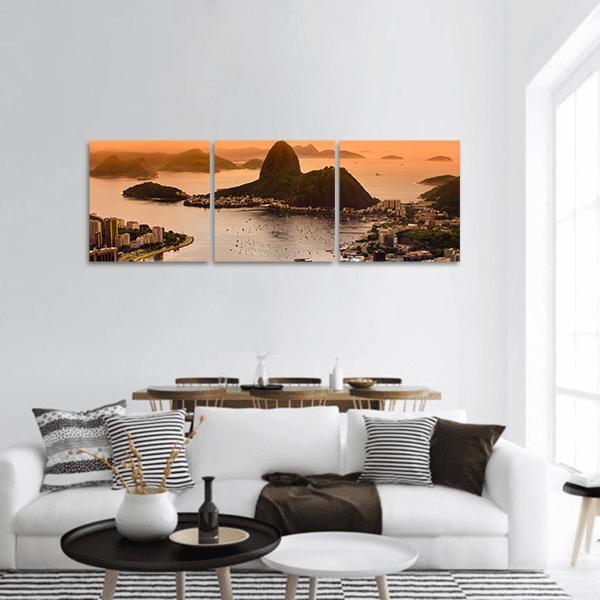 Sugarloaf and Botafogo Beach at Sunset Panoramic Canvas Wall Art in brown and orange, hung on a wall
