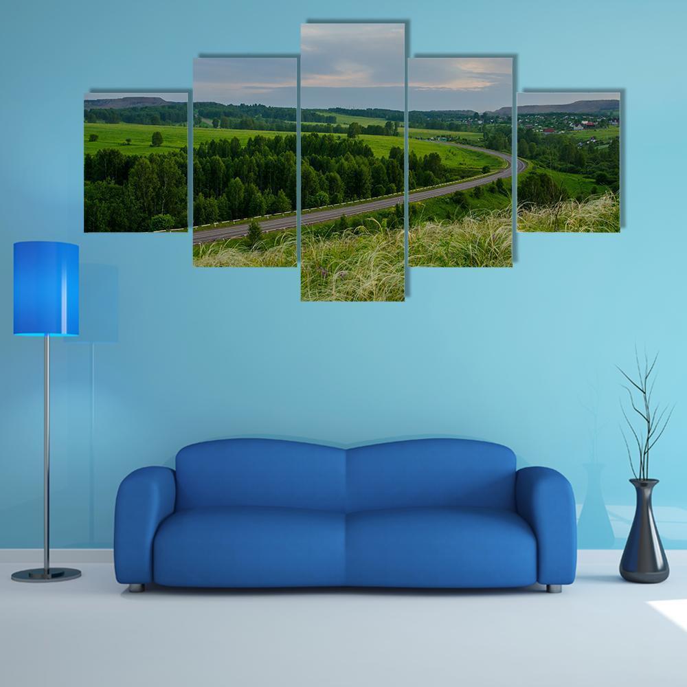 Winding Road at Summer Sunset Canvas Wall Art in gray, green and blue, 5 panel Star layout hung on a wall