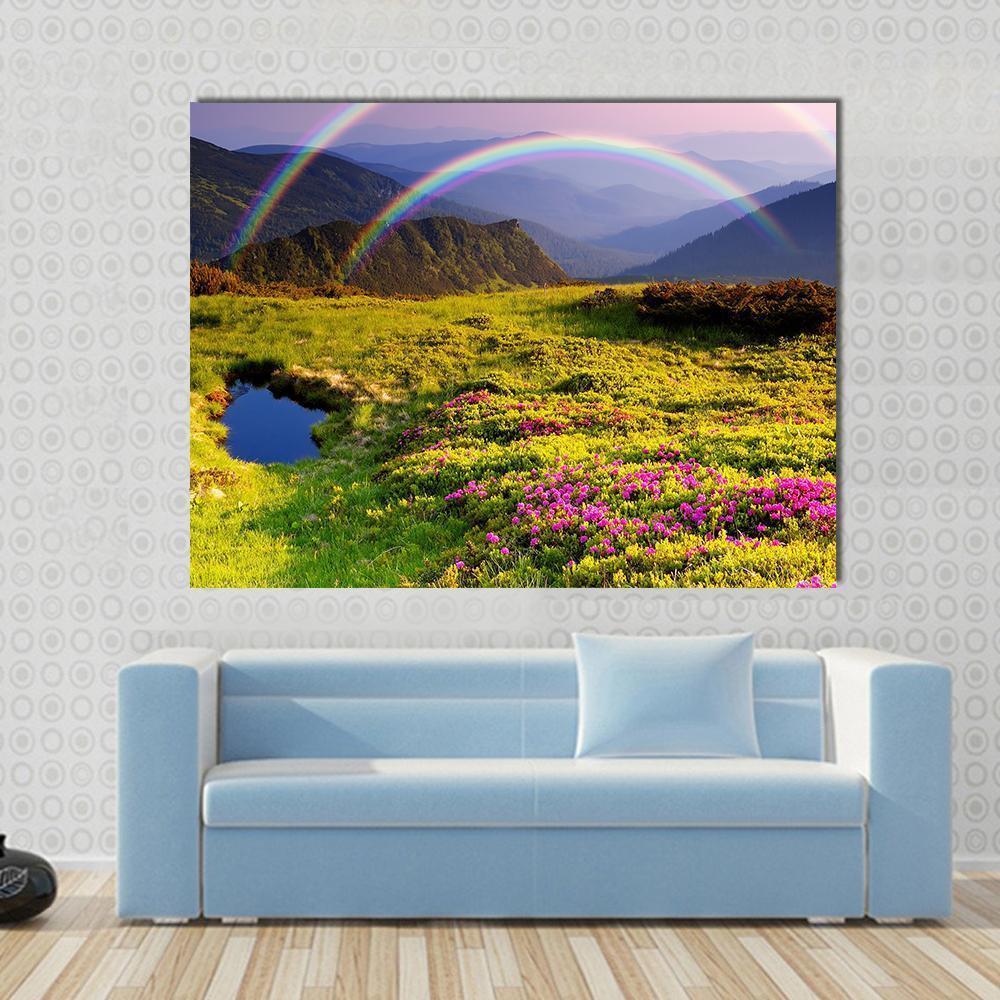 Double Rainbow Over Mountain Lake Canvas Wall Art in green, blue and purple, single panel hung on a wall