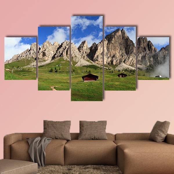 Summer Mountain Meadow with Two Wooden Cabins Canvas Wall Art in gray, green and blue, 5 panel Star layout hung on a wall