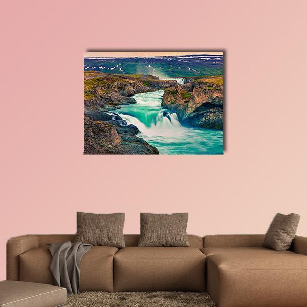 Summer Morning at Godafoss Waterfall Canvas Wall Art in brown, green and blue, single panel hung on a wall