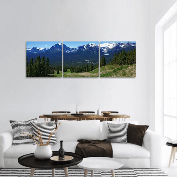 Banff Summer Mountain View Panoramic Canvas Wall Art in green and blue, hung on a wall