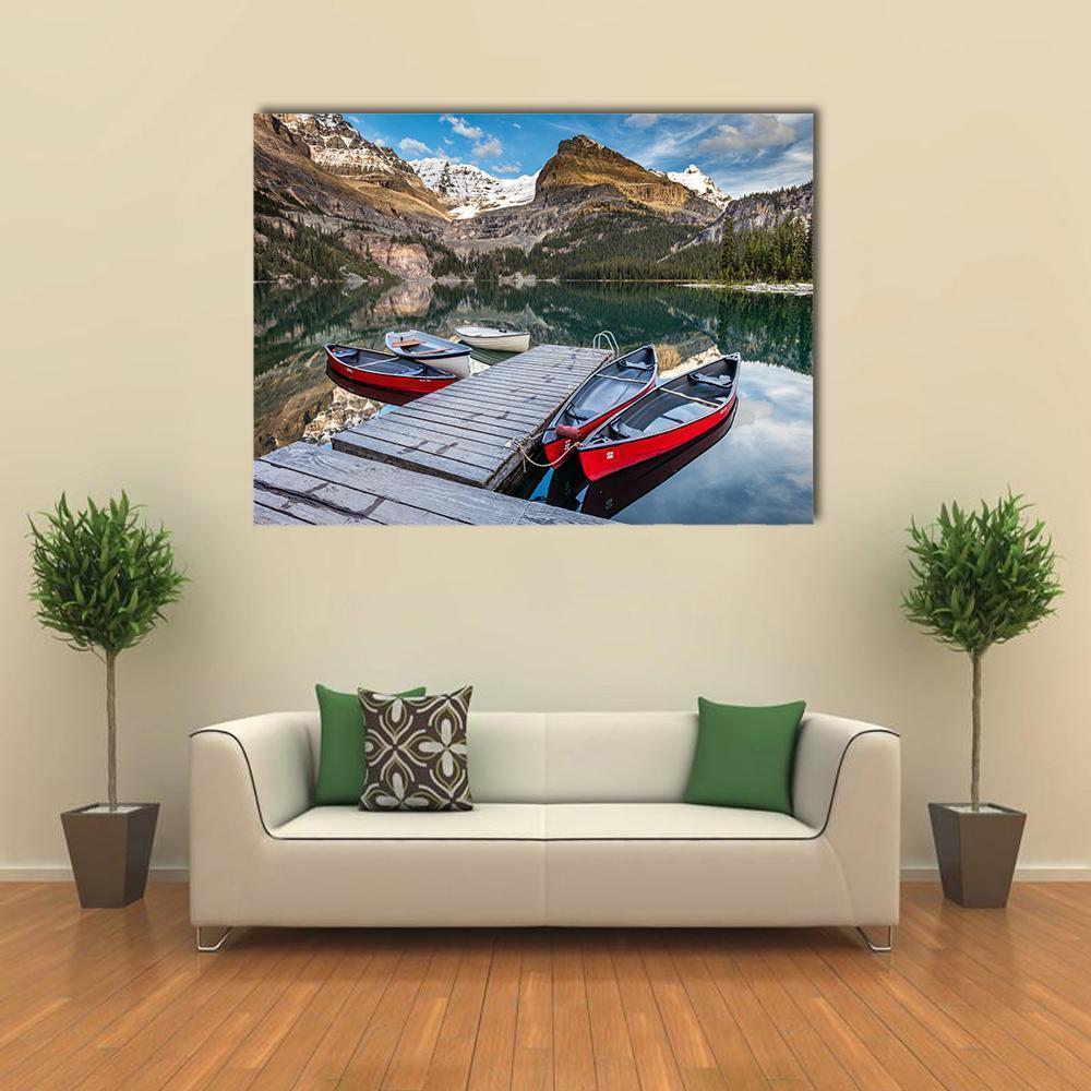 Red Canoes at Alpine Lake Canvas Wall Art in gray, brown and blue, single panel hung on a wall