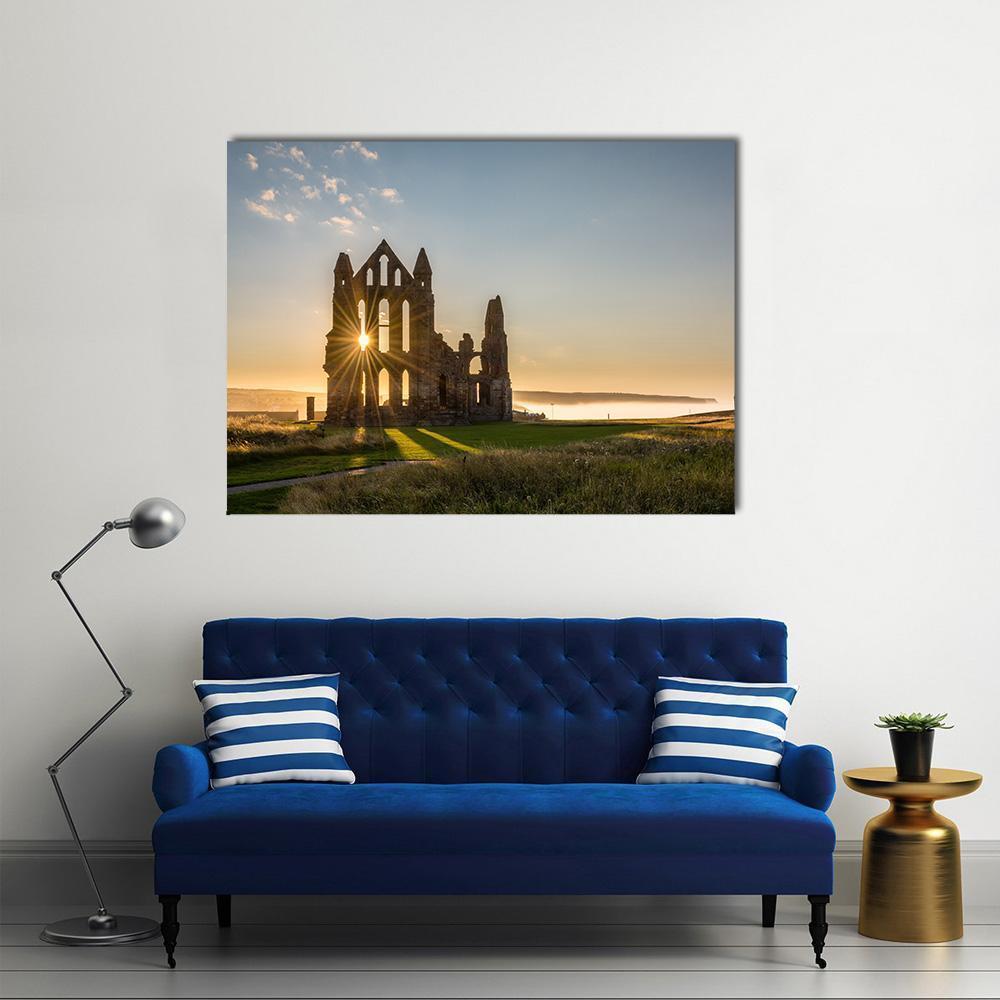 Sunburst Over Whitby Abbey Canvas Wall Art in yellow, green and blue, single panel hung on a wall