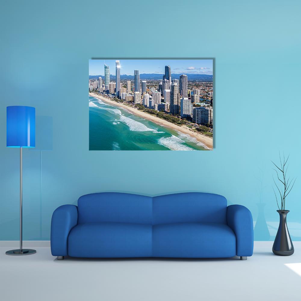 Coastal City Skyline Over Turquoise Shoreline Canvas Wall Art in white, beige and blue, single panel hung on a wall
