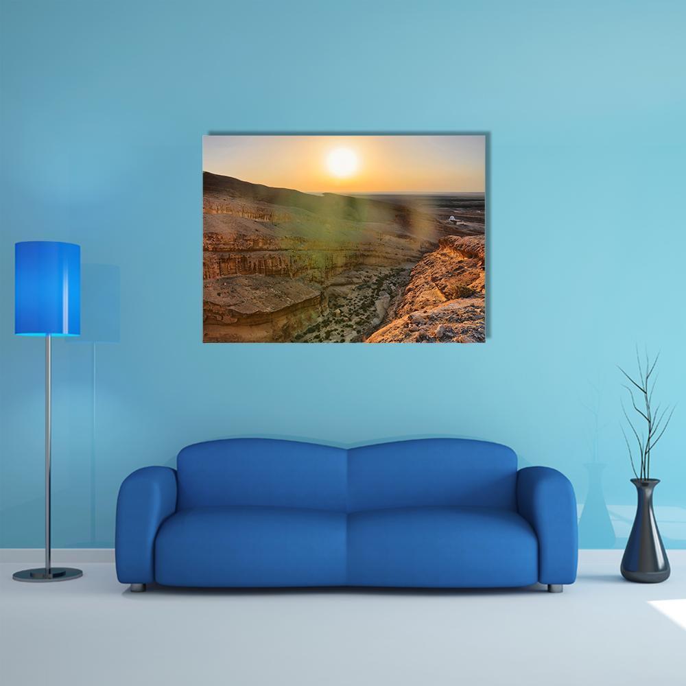 Sunrise Over Desert Canyon Canvas Wall Art in brown, orange and yellow, single panel hung on a wall